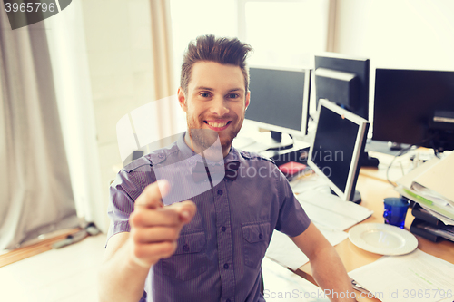 Image of happy male office worker pointing finger at you