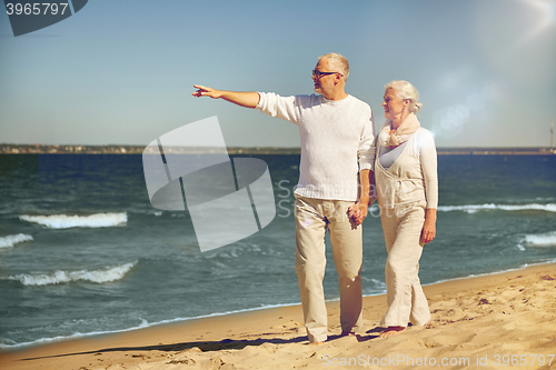 Image of happy senior couple on summer beach