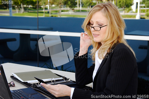 Image of Business woman working outside on lunch break
