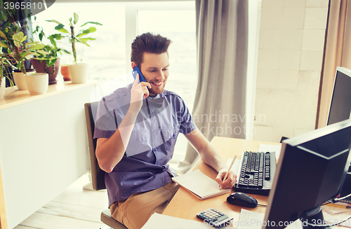 Image of happy creative male worker calling on smarphone