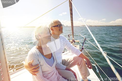 Image of senior couple hugging on sail boat or yacht in sea