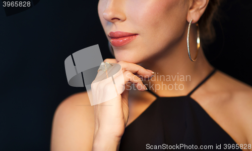 Image of beautiful woman in black wearing diamond jewelry