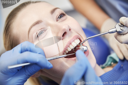 Image of close up of dentist treating female patient teeth