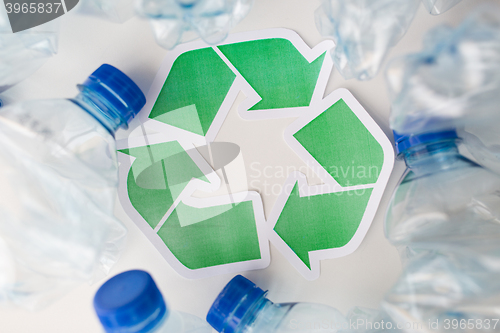 Image of close up of plastic bottles and recycling symbol