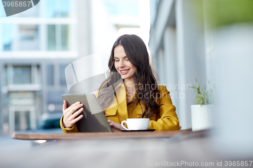 Image of happy woman with cocoa and tablet pc at city cafe