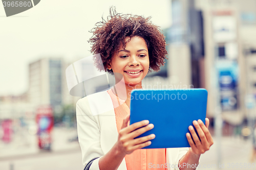 Image of happy african businesswoman with tablet pc in city