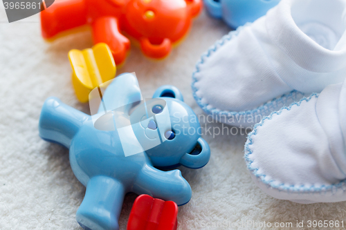 Image of close up of baby rattle and bootees for newborn