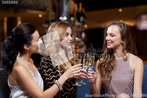 Image of happy women with champagne glasses at night club