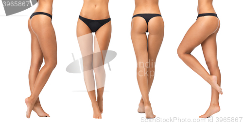 Image of female legs and bottom in black bikini panties