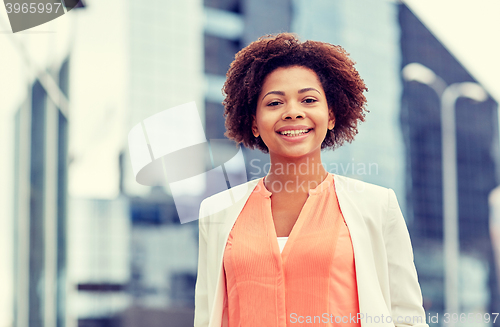 Image of happy young african american businesswoman in city