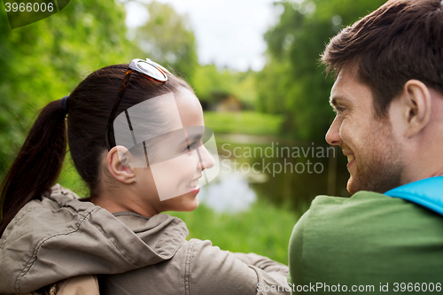 Image of smiling couple with backpacks in nature