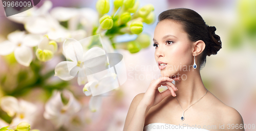 Image of beautiful asian woman with earring and pendant