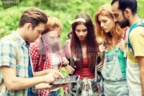 Image of friends with backpacks and tablet pc hiking