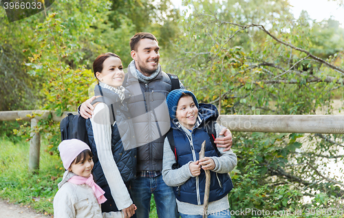 Image of happy family with backpacks hiking