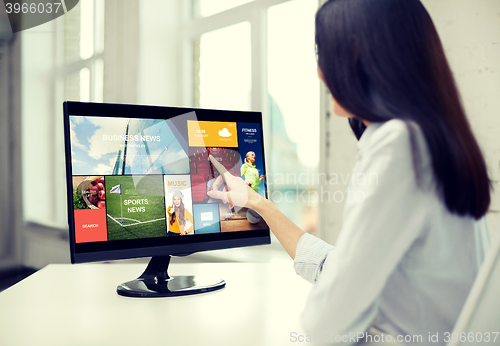 Image of close up of woman with news on computer in office