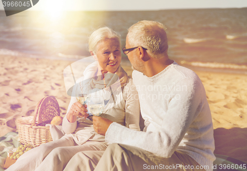 Image of happy senior couple talking on summer beach