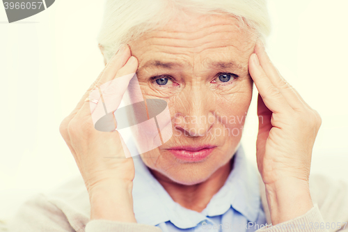 Image of face of senior woman suffering from headache