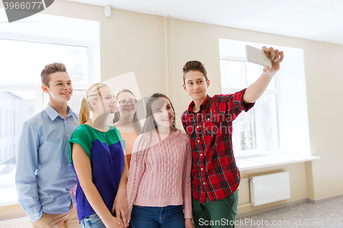 Image of group of students taking selfie with smartphone