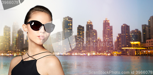 Image of beautiful young woman in elegant black sunglasses