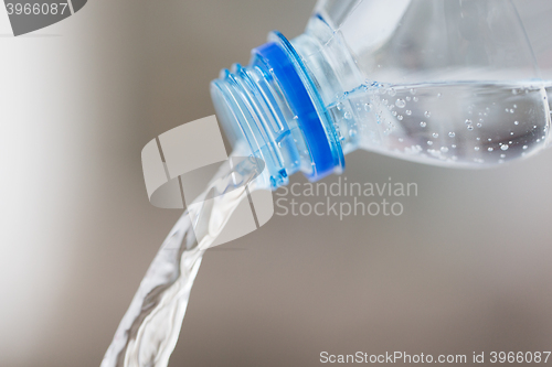 Image of close up of water pouring from plastic bottle