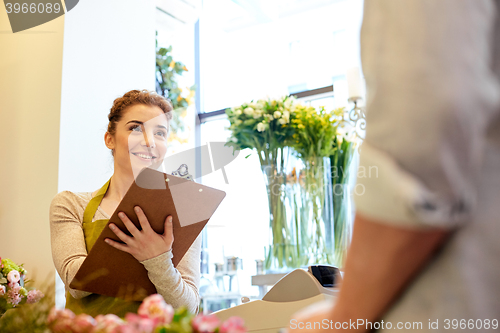 Image of florist woman and man making order at flower shop