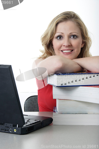 Image of Happy girl leaning on textbooks