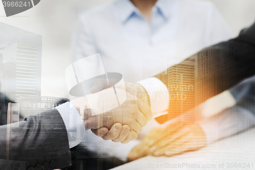 Image of two businessmen shaking hands in office