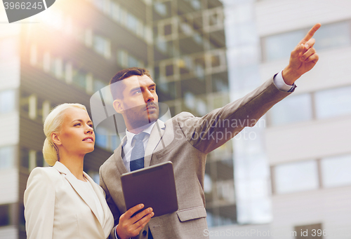 Image of serious businessmen with tablet pc outdoors