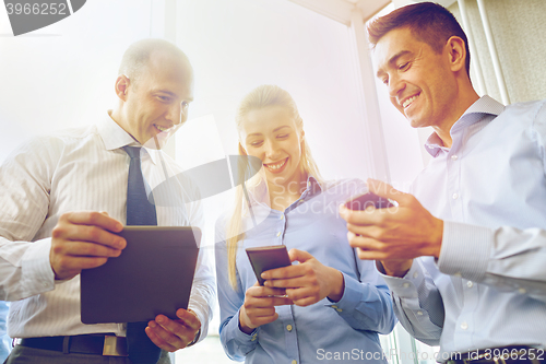 Image of business people with tablet pc and smartphones