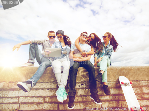 Image of group of teenagers looking at tablet pc