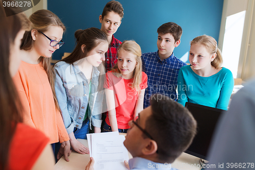 Image of group of students and teacher with tests at school