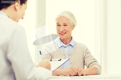 Image of doctor with clipboard and senior woman at hospital