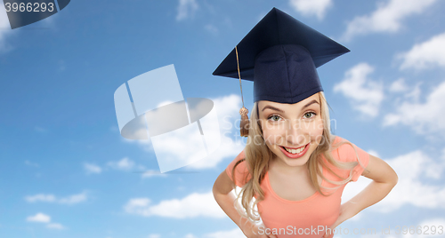 Image of smiling young student woman in mortarboard