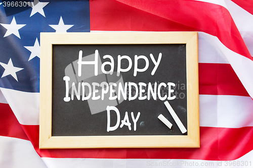 Image of blackboard ands american flag on independence day