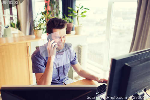 Image of happy creative male worker calling on smarphone