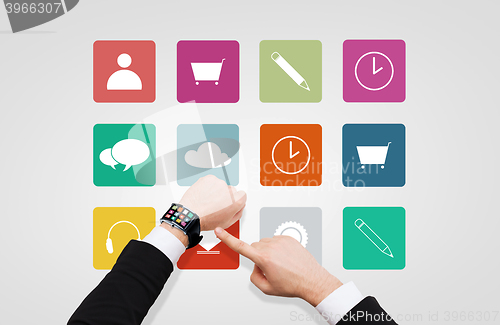 Image of businessman pointing to smart watch at his hand