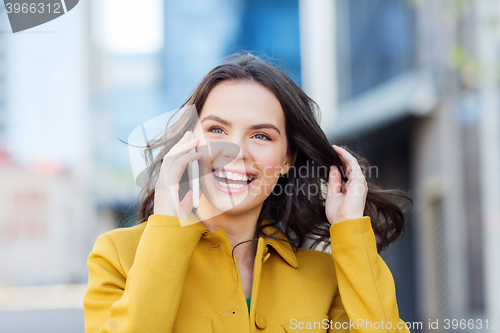 Image of smiling young woman or girl calling on smartphone