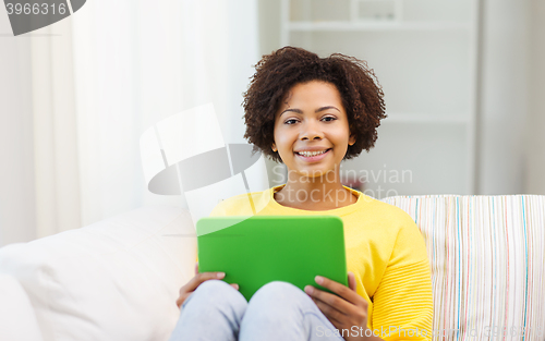 Image of happy african american woman with tablet pc