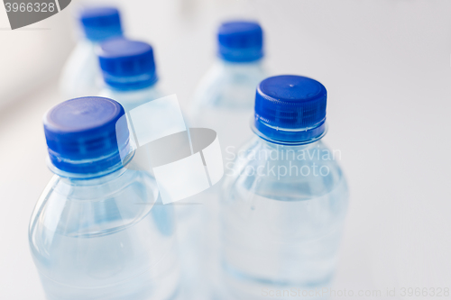 Image of close up of bottles with drinking water on table