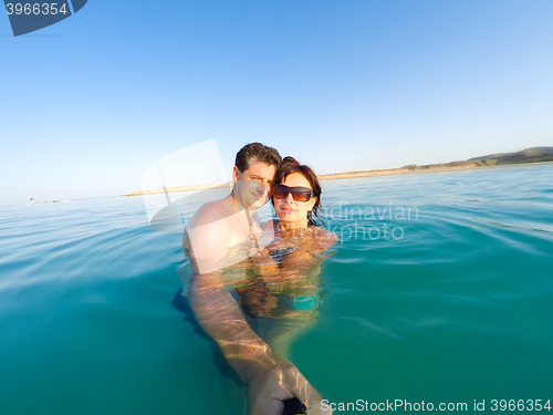 Image of Couple having fun in the water summertime holidays