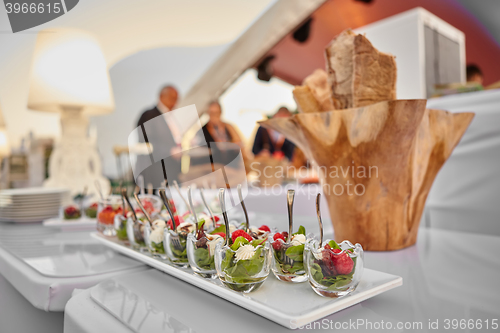 Image of appetizer with cream cheese, raspberry and beet leaves