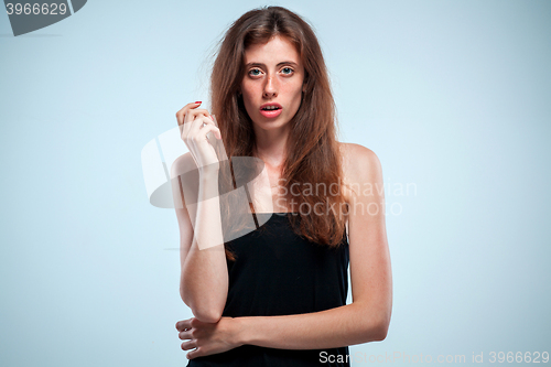 Image of Portrait of young woman with shocked facial expression