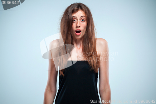 Image of Portrait of young woman with shocked facial expression