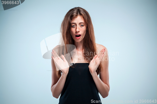 Image of Portrait of young woman with shocked facial expression