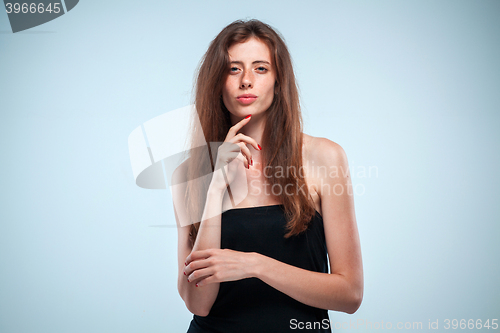 Image of The thoughtful woman on gray background