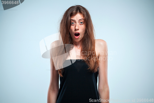 Image of Portrait of young woman with shocked facial expression