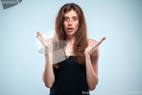 Image of Portrait of young woman with shocked facial expression