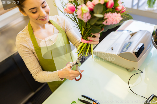 Image of close up of woman with flowers and scissors
