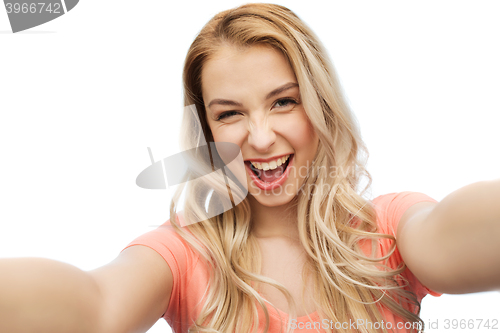 Image of happy smiling young woman taking selfie