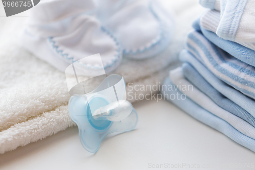 Image of close up of soother and baby clothes for newborn